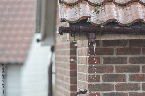 Broken gutter missing a downpipe. House guttering repair leaking rain water