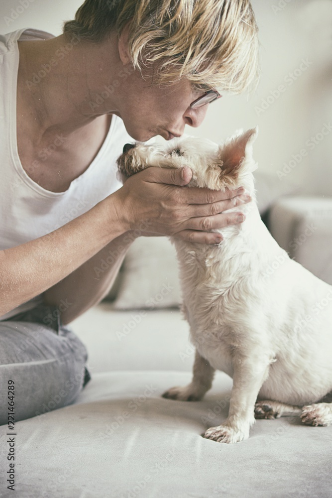 Old woman kissing a dog