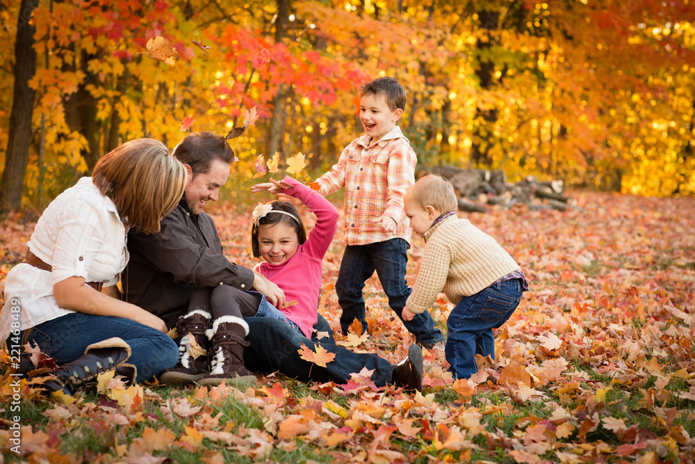 Family Laughing and Playing in Autumn Park Family Laughing and Playing in Autumn Park