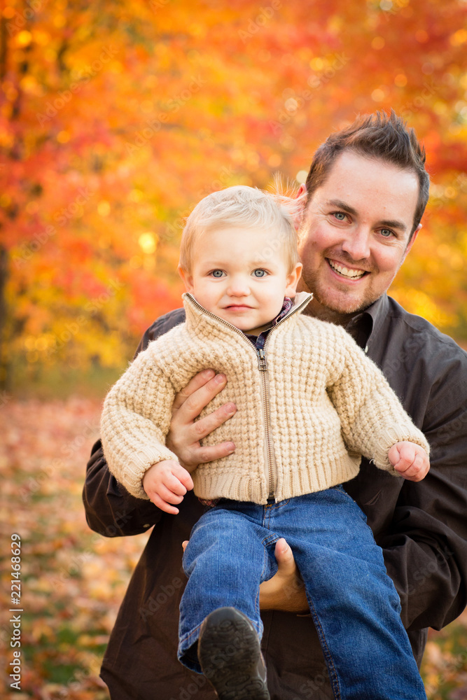 Happy Father Holding Son in Autumn Woods Happy Father Holding Son in Autumn Woods