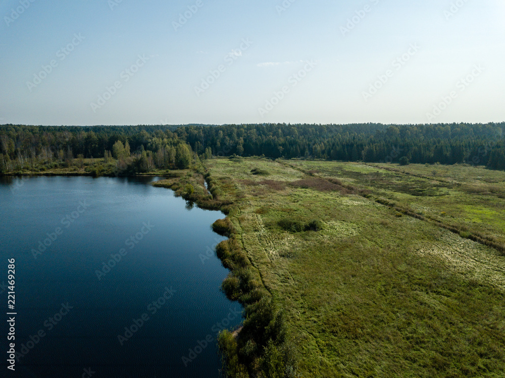 Obraz premium drone image. aerial view of rural area with fields and forest lake