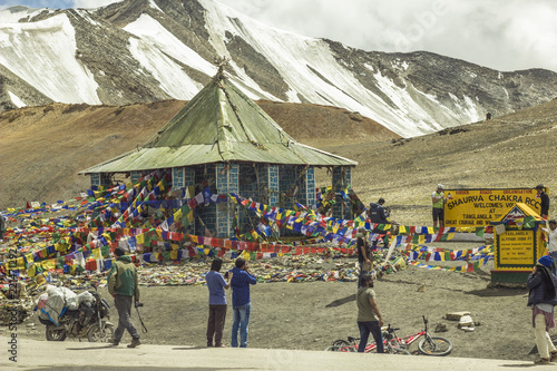 Ladakh, Jammu and Kashmir/India - 26.07.2018. Alpine road and Buddhist temple with flags