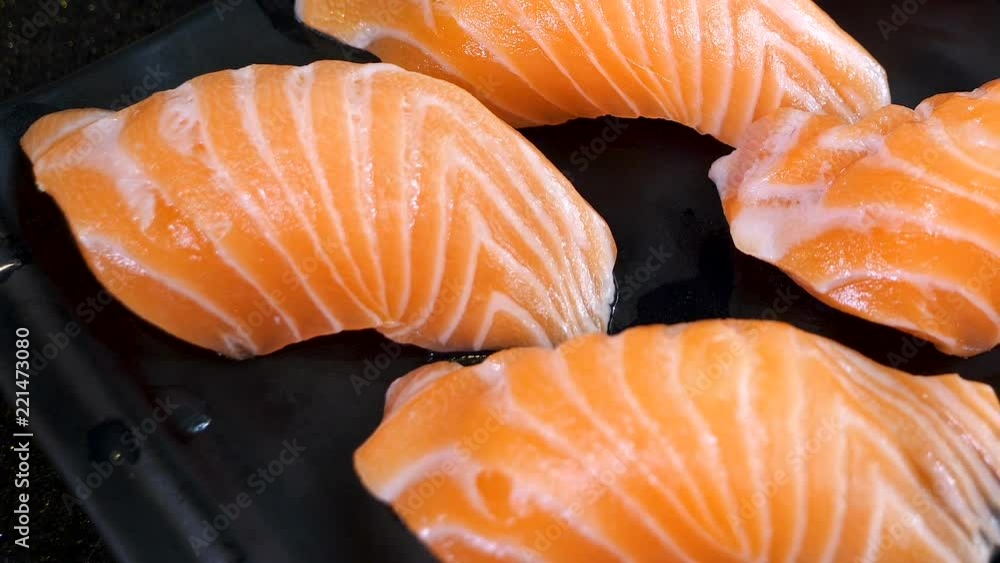 Motion video of salmon sushi on black dish in the restaurant (Selective Focus) Motion video of salmon sushi on black dish in the restaurant (Selective Focus)