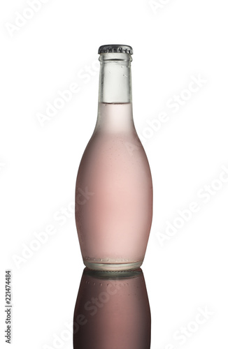 Glass bottle of pink soda with condensation on white background with reflection (ID: 221474484)
