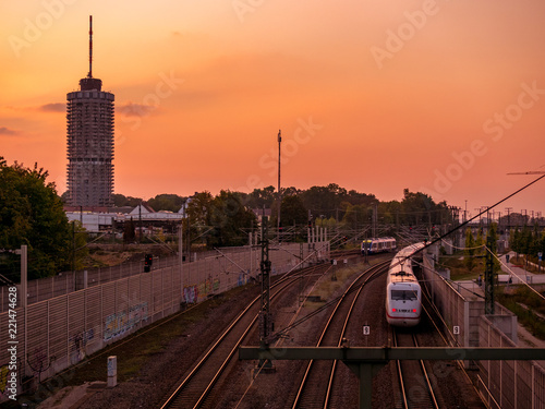 Fotografie Sunset in Augsburg with railway and tower