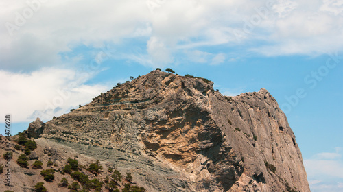 Rock against a cloudy sky background