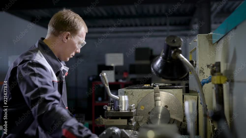 one worker in factory on the machine. a man at work on a lathe. Manufacture of tooling one worker in factory on the machine. a man at work on a lathe. Manufacture of tooling