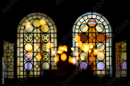 Stained glass windows in church and candles photo