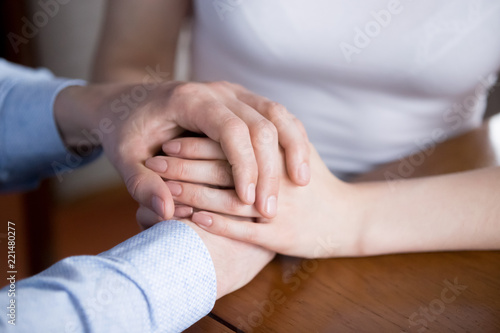 Εκτύπωση καμβά Close up of man and woman holding hands showing love and empathy, couple reconciled give support or comfort to spouse, male caress female expressing understanding and care