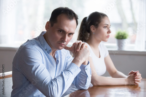 Stubborn couple avoid looking at each other after serious family fight, man and woman not talking sit separately having disagreement, spouses unwilling to communicate after conflict or argument