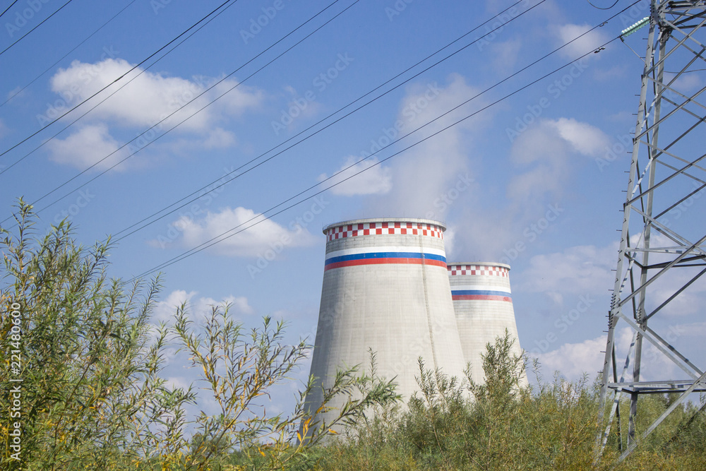 the towers of the power plant stand against the blue sky the towers of the power plant stand against the blue sky