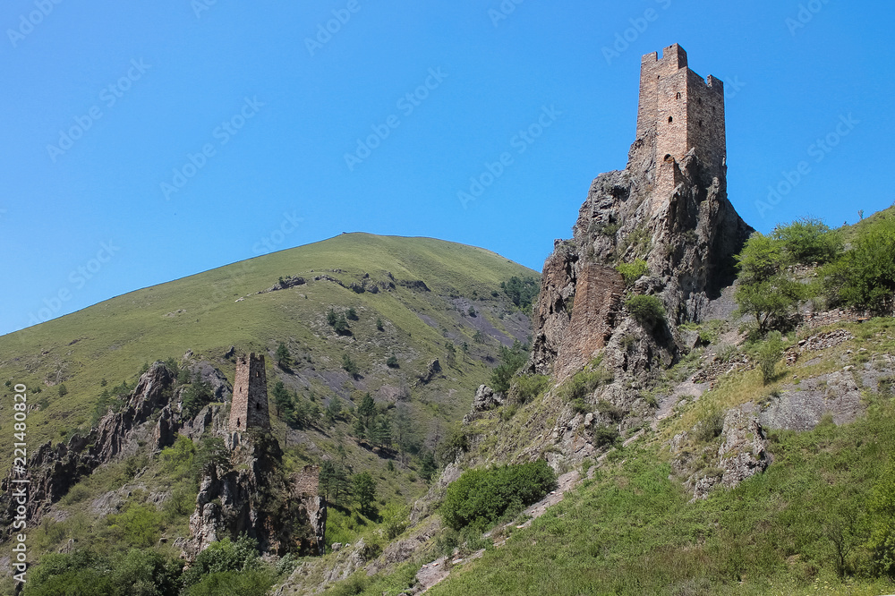 Aerial view from the drone. Mountain Ingushetia, medieval tower complex Vovnushki-stone towers standing on the rocks.