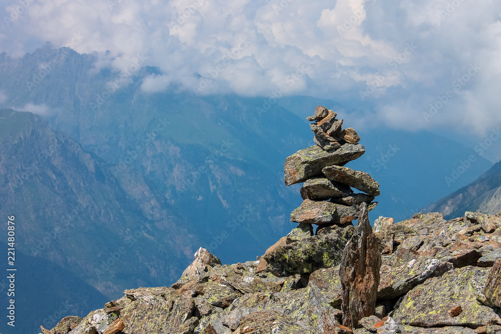 Balanced stones at the top of the mountain. Summer mountain landscapes of Karachay Cherkessia, Dombay, Western Caucasus. Balanced stones at the top of the mountain. Summer mountain landscapes of Karachay Cherkessia, Dombay, Western Caucasus.