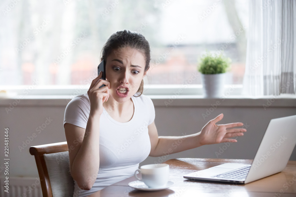 Furious woman argue talking on phone having problems with boyfriend or lover, mad female call customer support have problems with laptop, angry girl scream during emotional conversation over phone Furious woman argue talking on phone having problems with boyfriend or lover, mad female call customer support have problems with laptop, angry girl scream during emotional conversation over phone