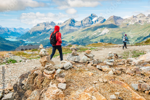 Fototapeta Naklejka Na Ścianę i Meble -  Young hikers walking on the Muragl valley in the area St.Moritz.