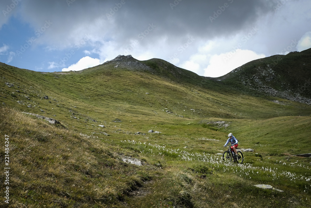 Fototapeta premium mountainbiker in action in the beautiful aosta valley, Italy, Europe