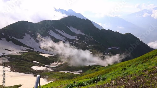 timelapse clouds are passing through Aibga Ridge. ski slope in summer. Mountains near the ski resort of Rosa Khutor in Krasnaya Polyana. Sochi. photo