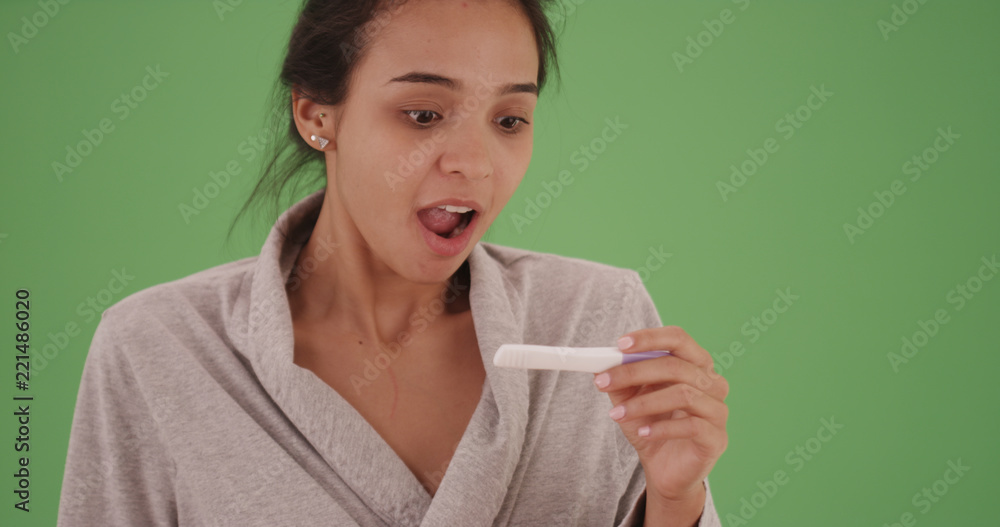 Surprised Latina girl finds out she is pregnant on green screen Surprised Latina girl finds out she is pregnant on green screen