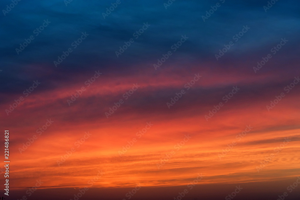 Dramatic sunset sky with blue and red clouds