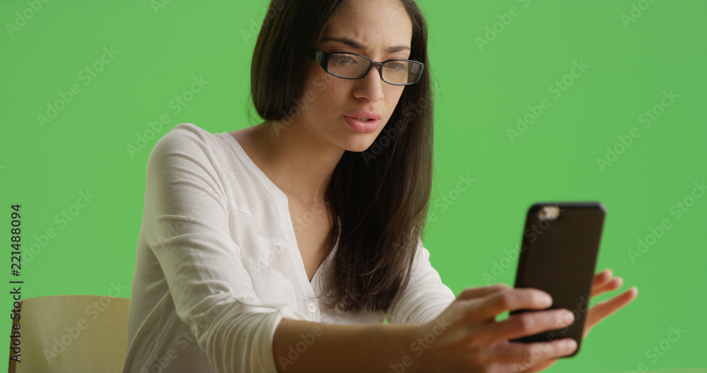 A Hispanic woman receiving concerning text message green screen