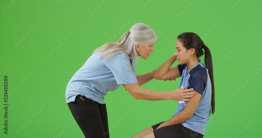 Soccer referee checks that the injured player is not concussed on green screen Soccer referee checks that the injured player is not concussed on green screen