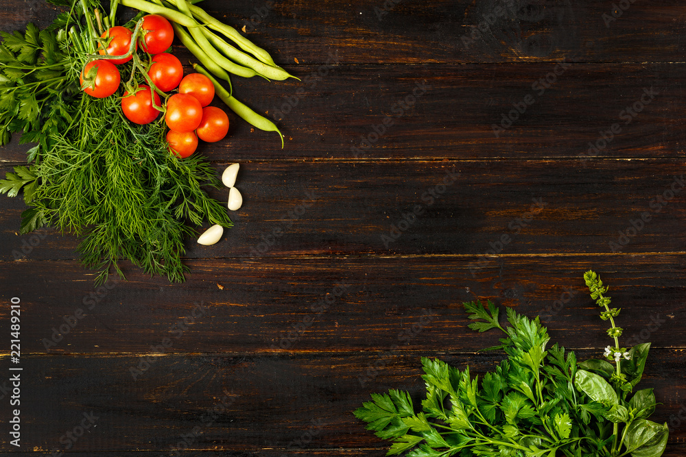 tomatoes, garlic, beans and seasonal greens on wooden background, top view tomatoes, garlic, beans and seasonal greens on wooden background, top view
