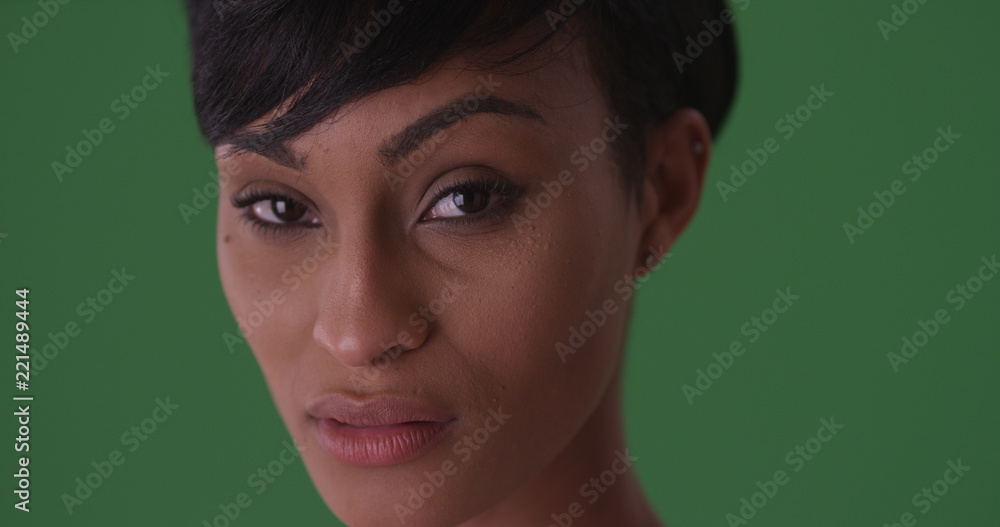 Close-up portrait of a young black woman with a serious face on green screen Close-up portrait of a young black woman with a serious face on green screen