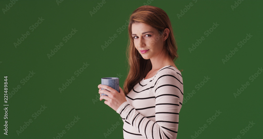 Attractive woman with coffee looking at camera on green screen Attractive woman with coffee looking at camera on green screen