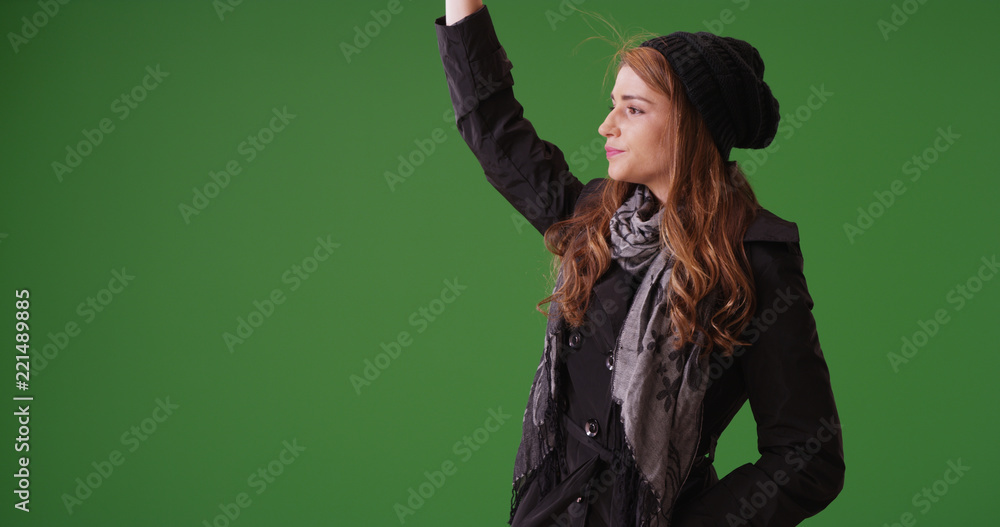 Attractive woman waving for a taxi cab to pick her up on green screen Attractive woman waving for a taxi cab to pick her up on green screen