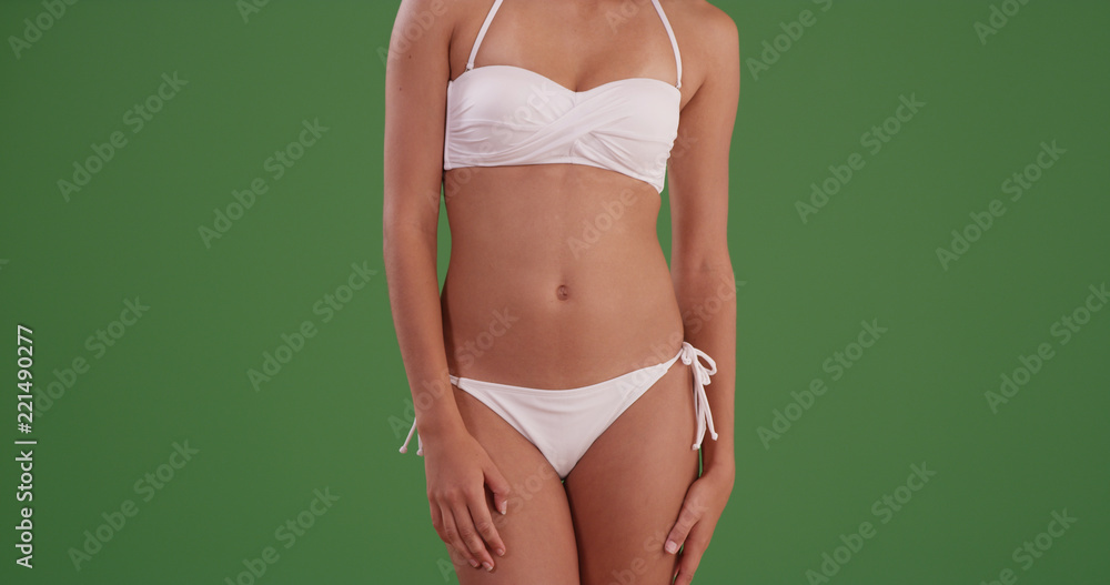 Portrait of attractive black woman's body in bikini on green screen