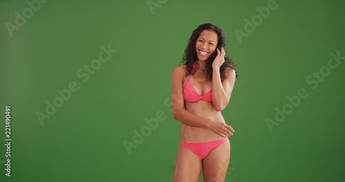 Sexy mixed race woman smiling wearing a bikini on green screen