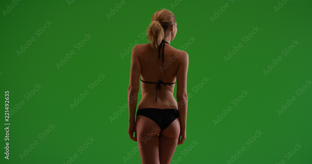 © Mark Adams - Rear view of attractive Caucasian bikini girl backlit on green screen © Mark Adams - Rear view of attractive Caucasian bikini girl backlit on green screen