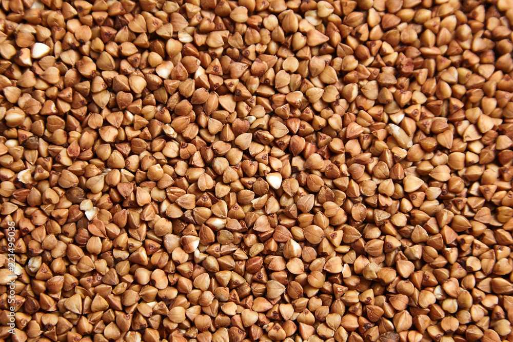 Buckwheat grains. Dry brown kernel as background Buckwheat grains. Dry brown kernel as background