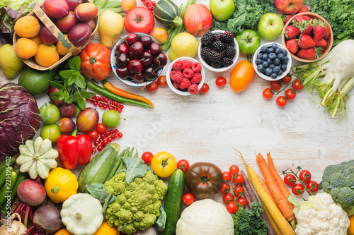 Healthy eating  summer fruits vegetables berries  cherries peaches strawberries cabbage broccoli cauliflower squash tomatoes carrots spring onions beans beetroot  copy space  top view  selective focus