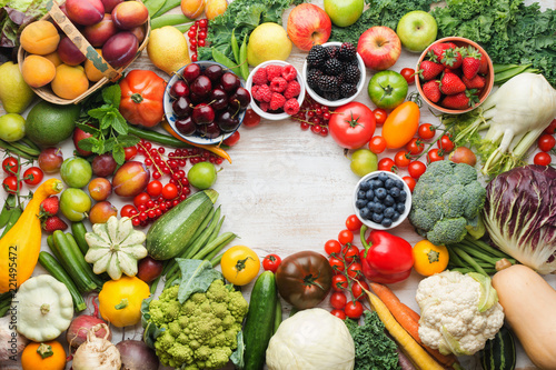 Fototapeta Naklejka Na Ścianę i Meble -  Healthy summer fruits vegetables berries arranged in a circle frame, cherries peaches strawberries cabbage broccoli cauliflower squash tomatoes carrots beetroot, copy space, top view, selective focus