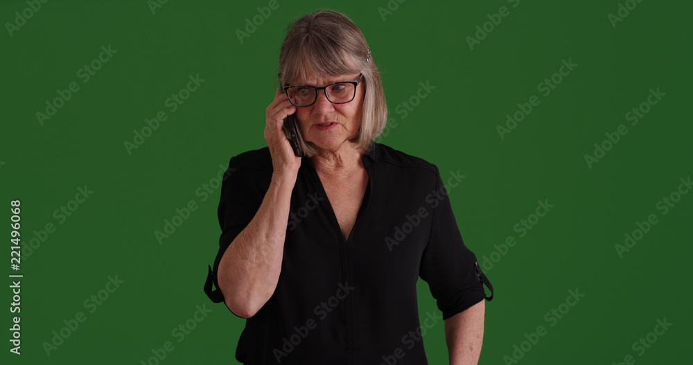 Casual old white woman talking on mobile device on green screen Casual old white woman talking on mobile device on green screen