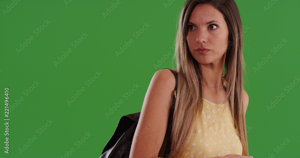 Portrait of Caucasian girl wearing backpack looking off screen on green screen Portrait of Caucasian girl wearing backpack looking off screen on green screen