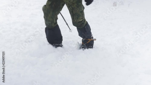 Wallpaper Mural Legs of climbers with special cats that climb the snow to the top, close-up. Torontodigital.ca