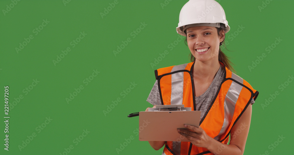 Female construction worker posing with clipboard on green screen Female construction worker posing with clipboard on green screen