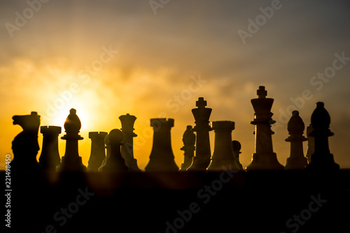 chess board game concept of business ideas and competition and strategy ideas. Chess figures on a chessboard outdoor sunset background.