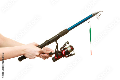 Person holding fishing rod, spinning equipment.