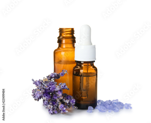 Fototapeta Naklejka Na Ścianę i Meble -  Bottles with aromatic lavender oil on white background