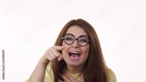 Woman laughing, looking at camera pointing you, showing loser gesture sign with L fingers on forehead. 4K ProRes HQ codec