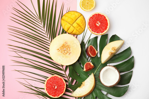 Flat lay composition with melon and other fruits on color background