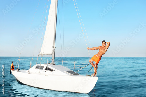 Young man relaxing on yacht during sea trip © New Africa