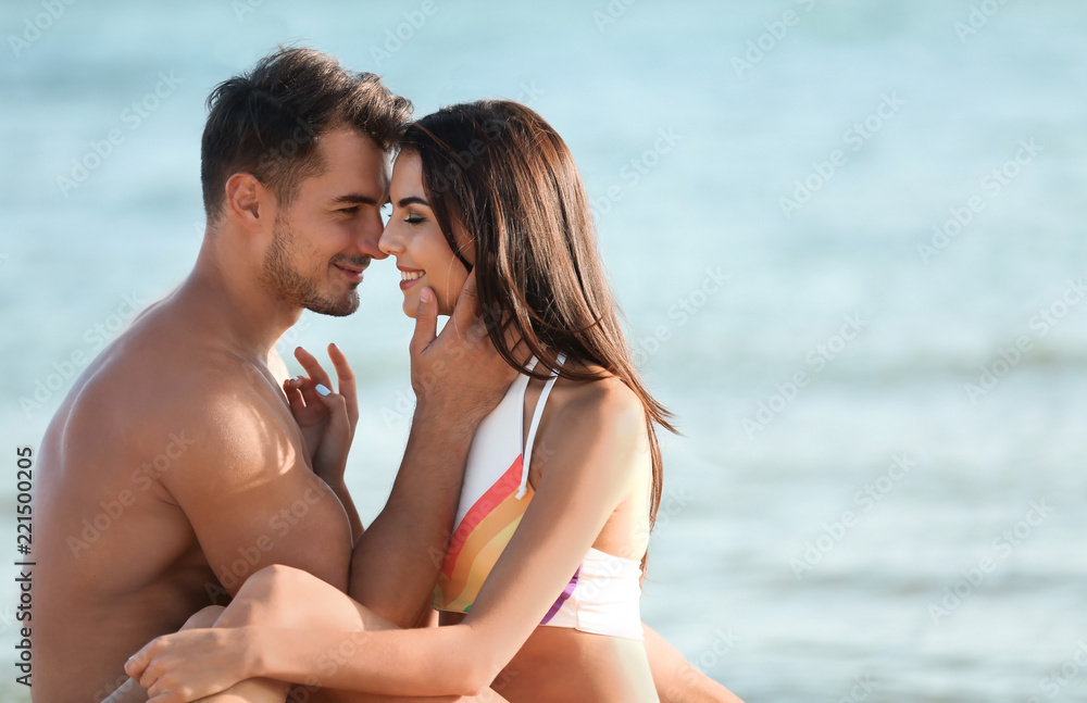 Fototapeta premium Happy young couple at beach on sunny day