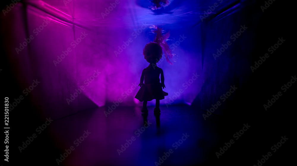 Creepy silhouette in the dark abandoned building. Horror about maniac concept or Dark corridor with cabinet doors and lights with silhouette of spooky horror person Creepy silhouette in the dark abandoned building. Horror about maniac concept or Dark corridor with cabinet doors and lights with silhouette of spooky horror person