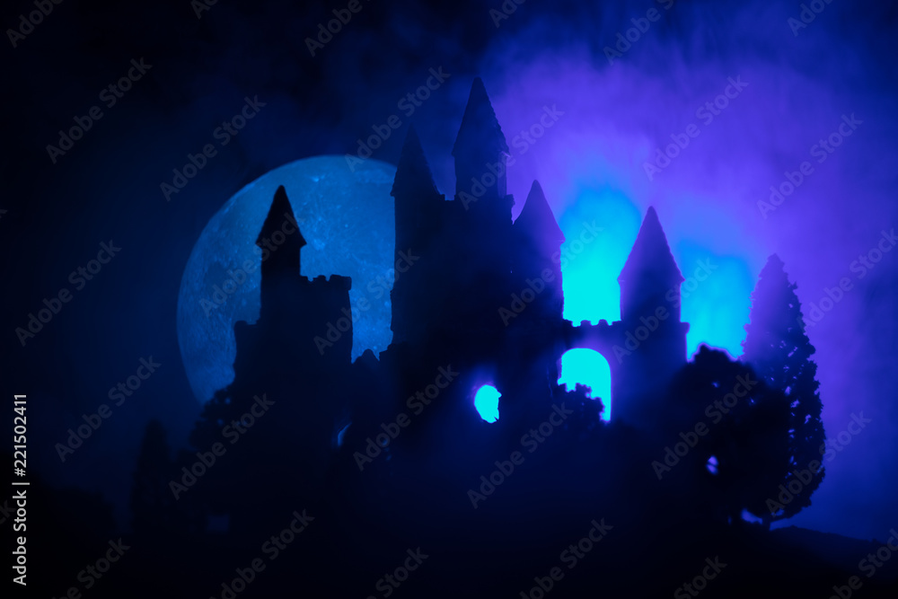Mysterious medieval castle in a misty full moon. Abandoned gothic style old castle at night Mysterious medieval castle in a misty full moon. Abandoned gothic style old castle at night