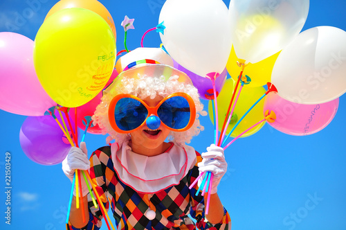 funny kid clown with balloons