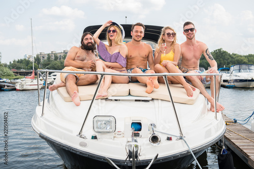 A company of young friends are sitting at the stern of a yacht © Oleksandr